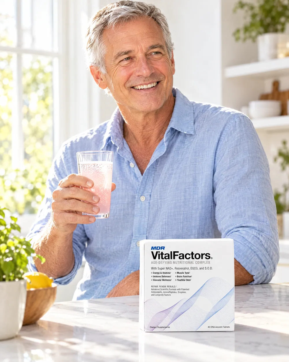 A man smiling with a glass of VitalFactors and the box on the counter