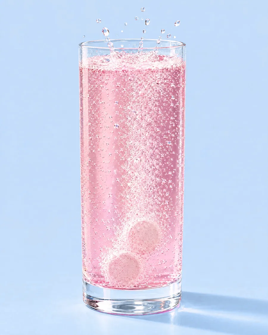 They dissolve completely and the water turns pink.