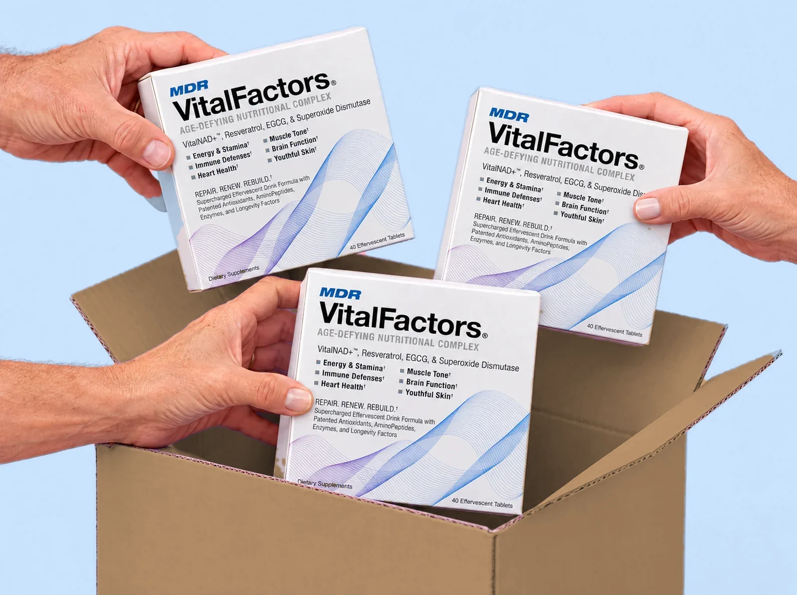 Hands lifting three boxes of VitalFactors out of a shipping box